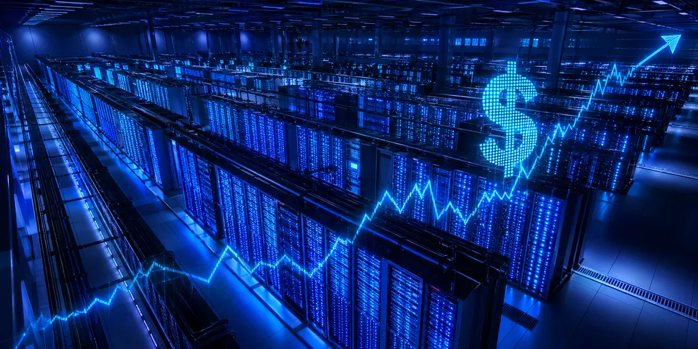 Massive data center interior with illuminated server racks glowing in deep blue and cyan, representing more than $130 billion in quarterly Big Tech AI infrastructure investment